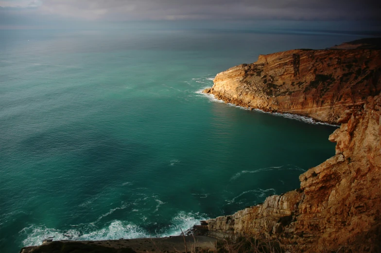 the ocean is very deep and blue on a cloudy day