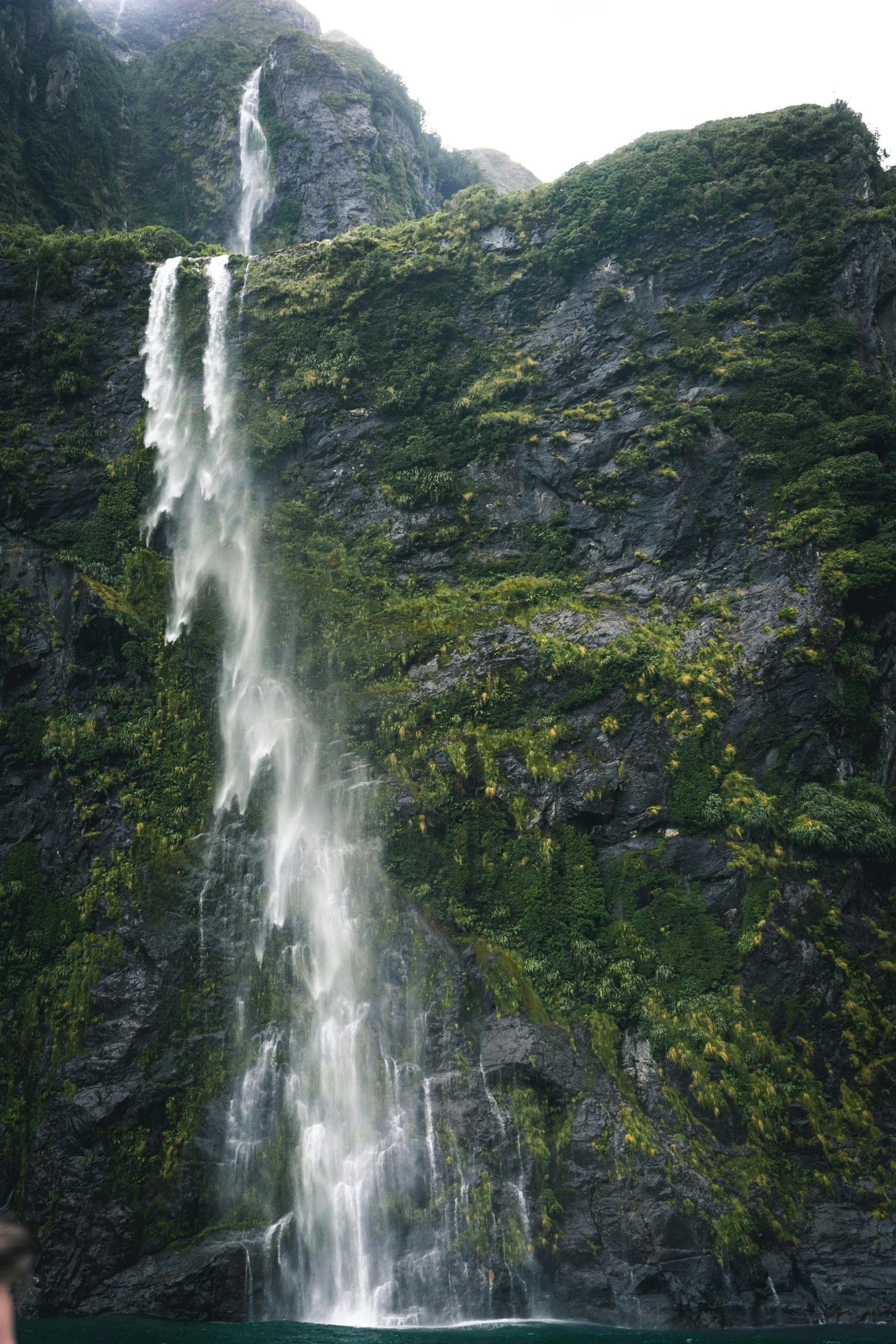 a waterfall, in the middle of an area that looks very green