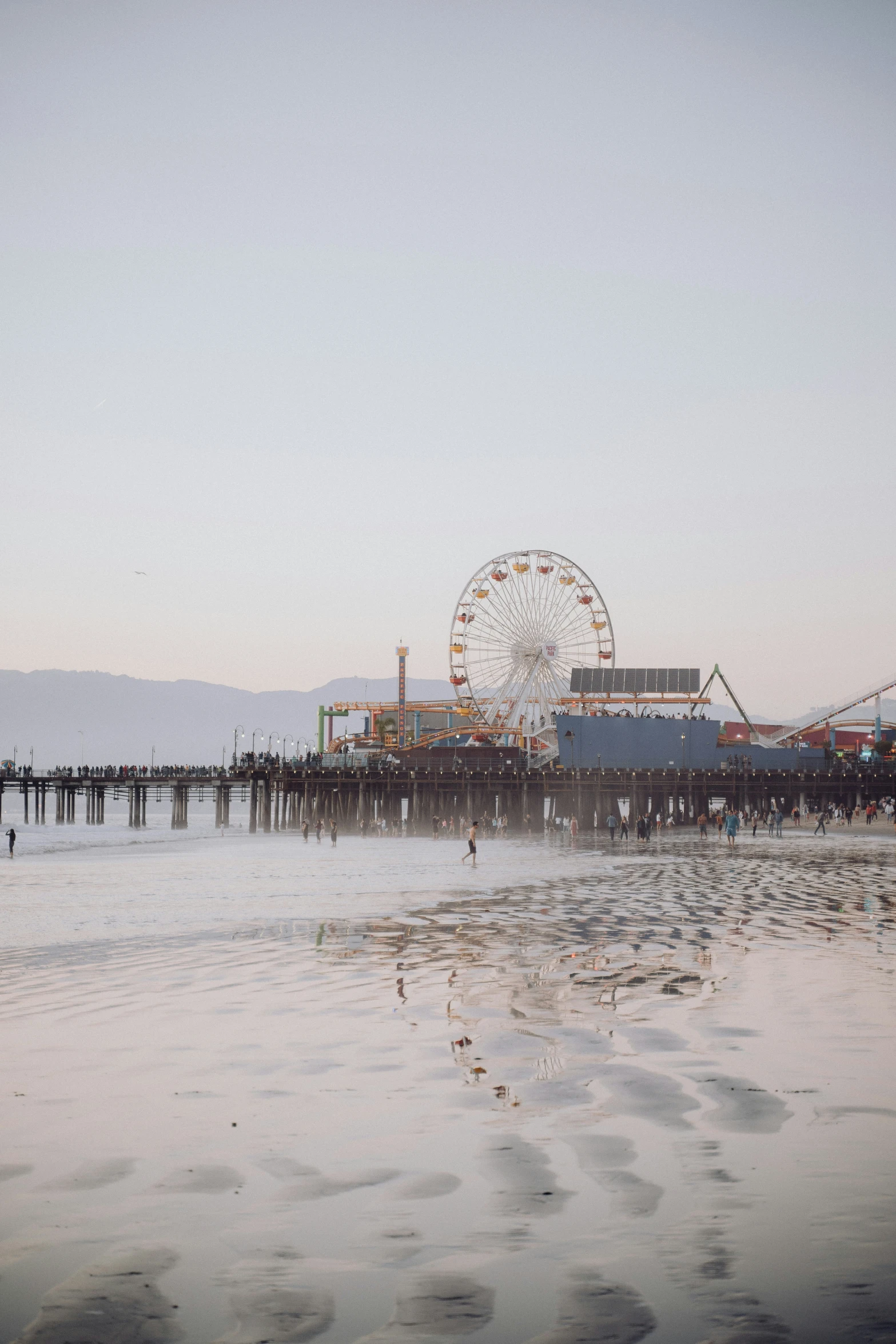 the pier with many rides is next to a small water park