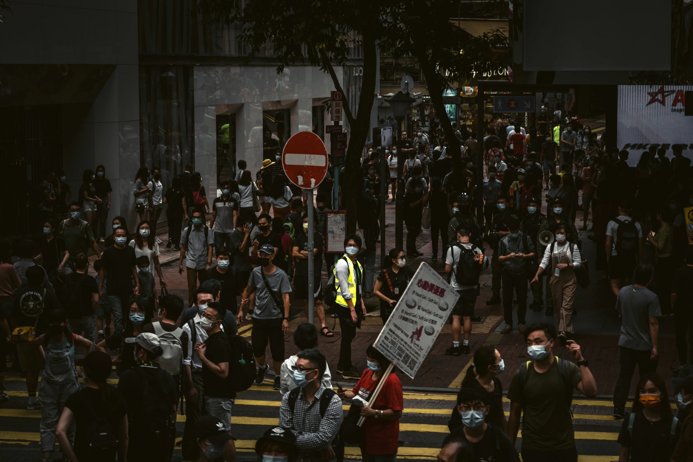 there is a bunch of people on the street wearing face masks