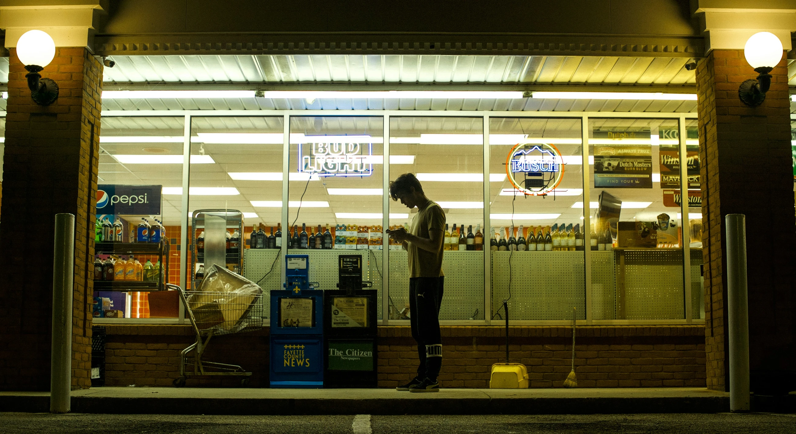 the person is standing outside of the business window