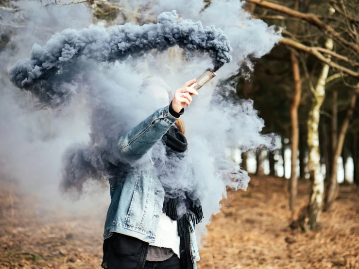 a woman using her phone while smoking a cigarette