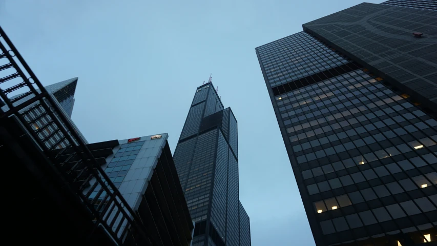several buildings towering against a cloudy blue sky