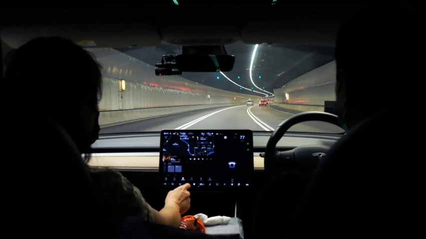 view from inside of a bus that is driving at night