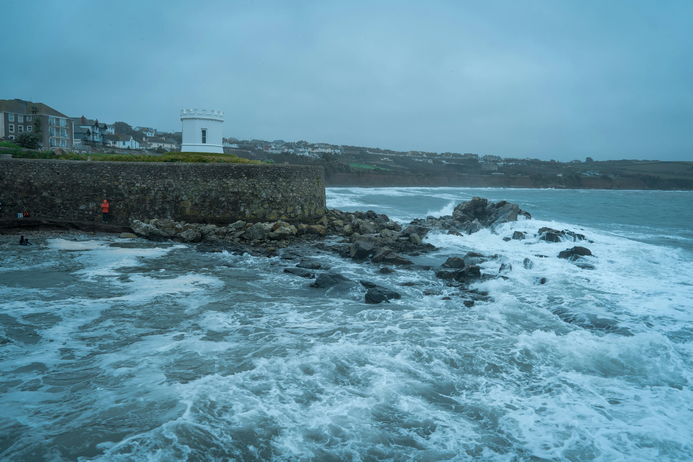 an image of waves crashing onto the rocks