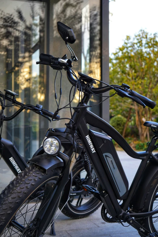 two bikes are parked next to each other outside