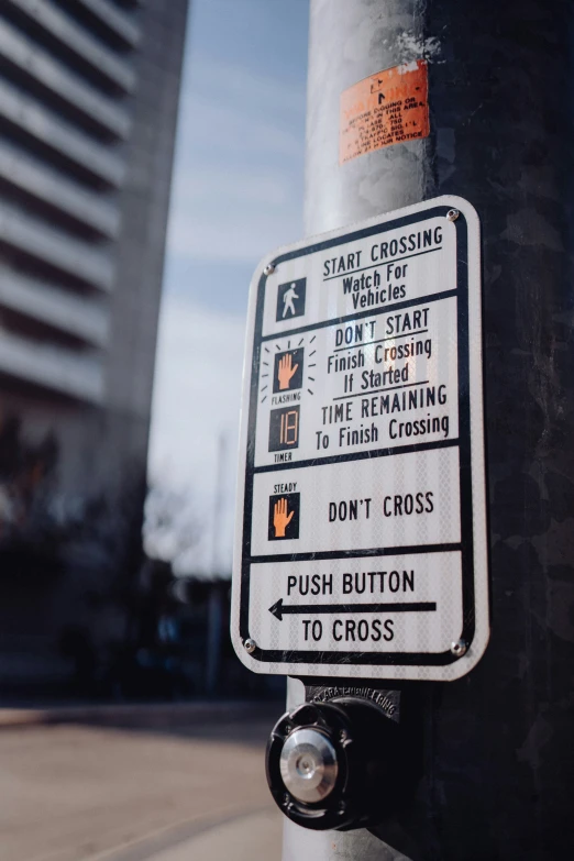 a street sign that warns of what to do with the crossing