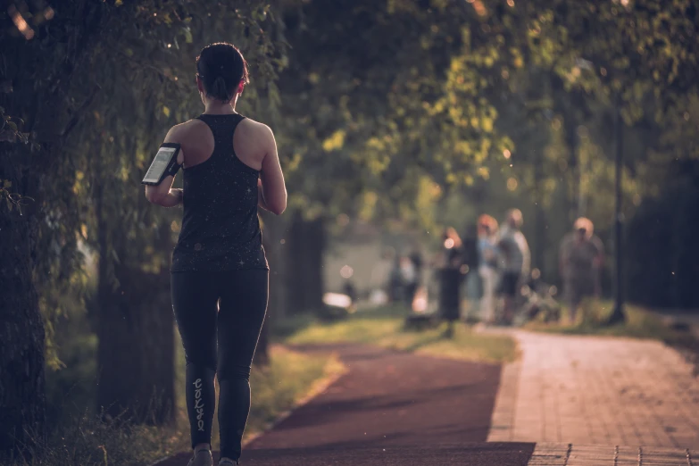 a woman runs down the side walk to get to her next race