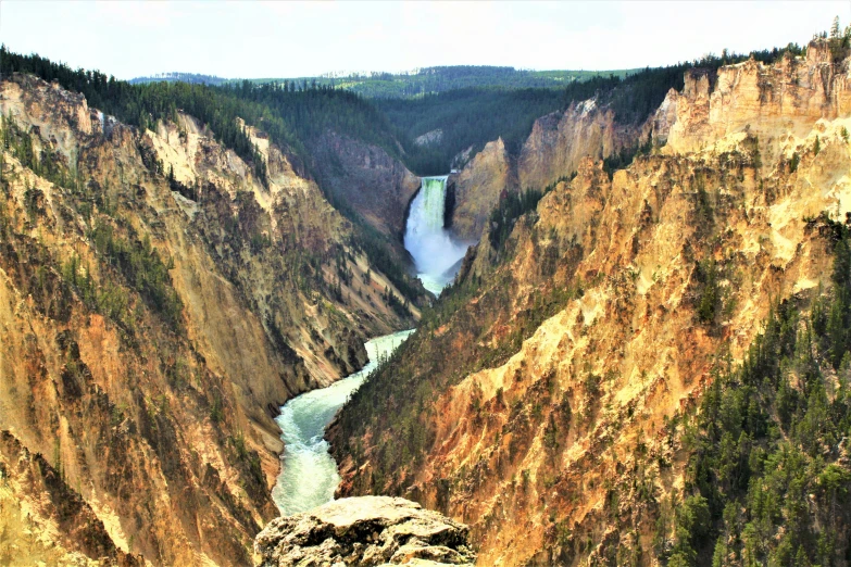 some cliffs a river and a few trees and water