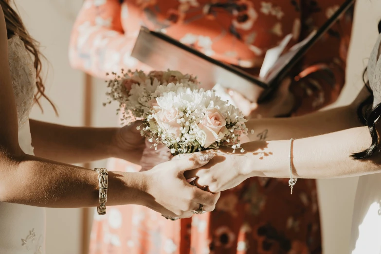 two women holding hands next to each other