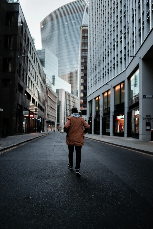 a man walks through an empty street in a city