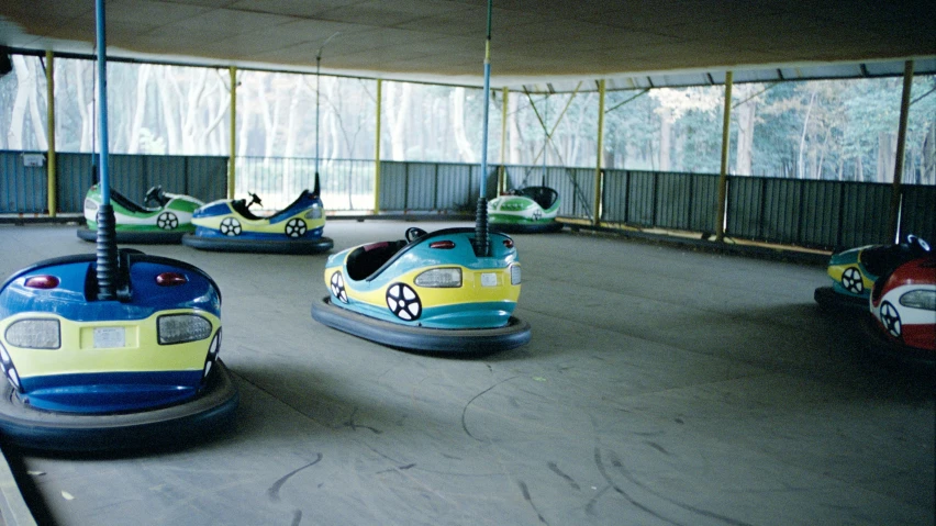 two children riding bumper cars in a park