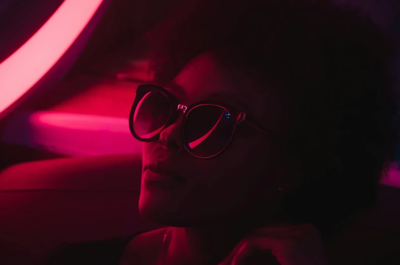 a woman with sunglasses is sitting in the car