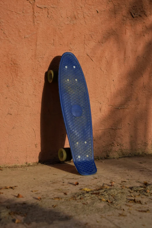 a skateboard leaning on the side of a wall