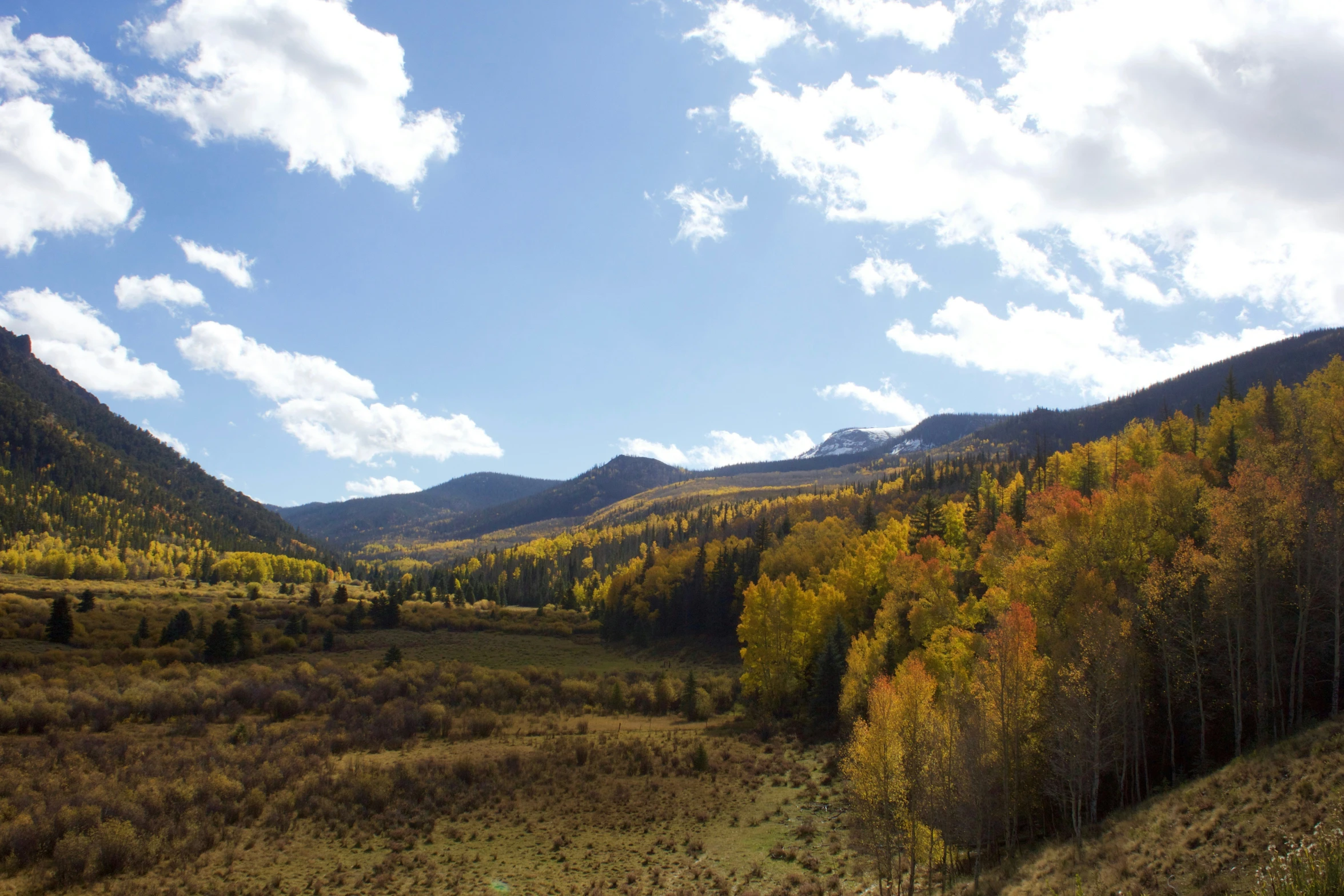 there is a view of some mountains and a field