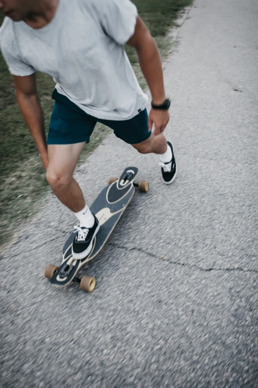 man on skateboard performing trick in paved area