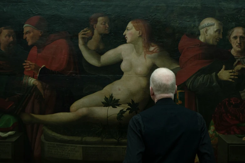 a man standing next to a painting in front of him