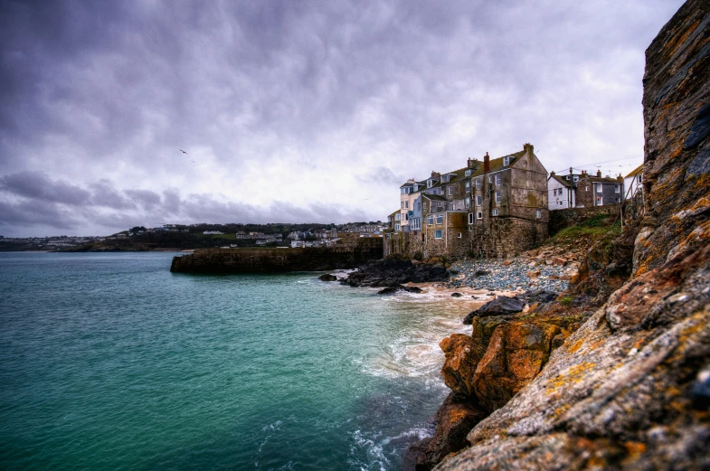 an ocean view of buildings on a rocky shore