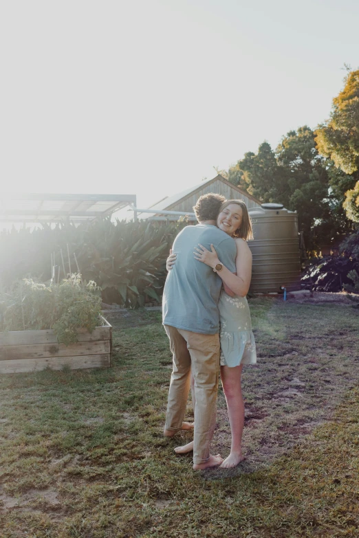 a couple emcing in the backyard near a house