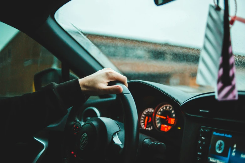 a man driving a car with a very bright red light