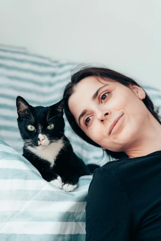 a lady lying in bed with a cat