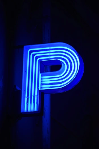 a blue neon sign lit up in the dark