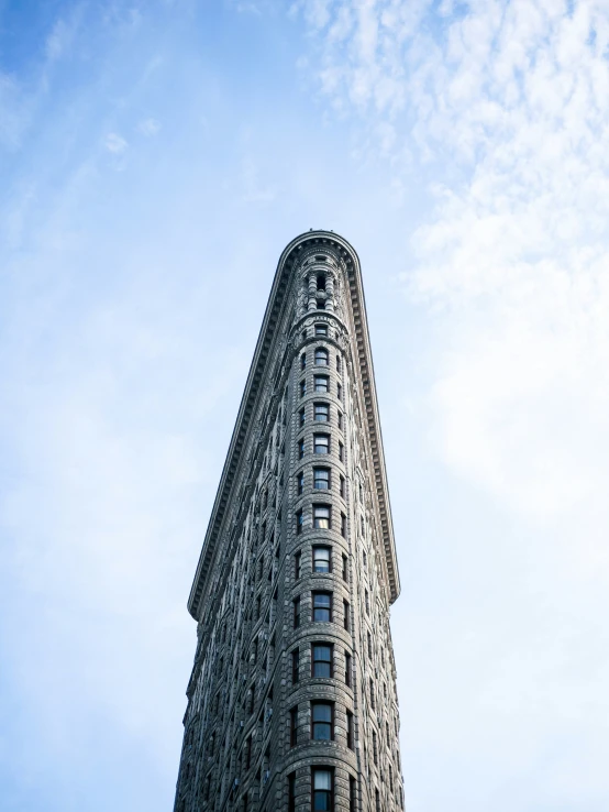 a large building sits beneath a cloudy sky