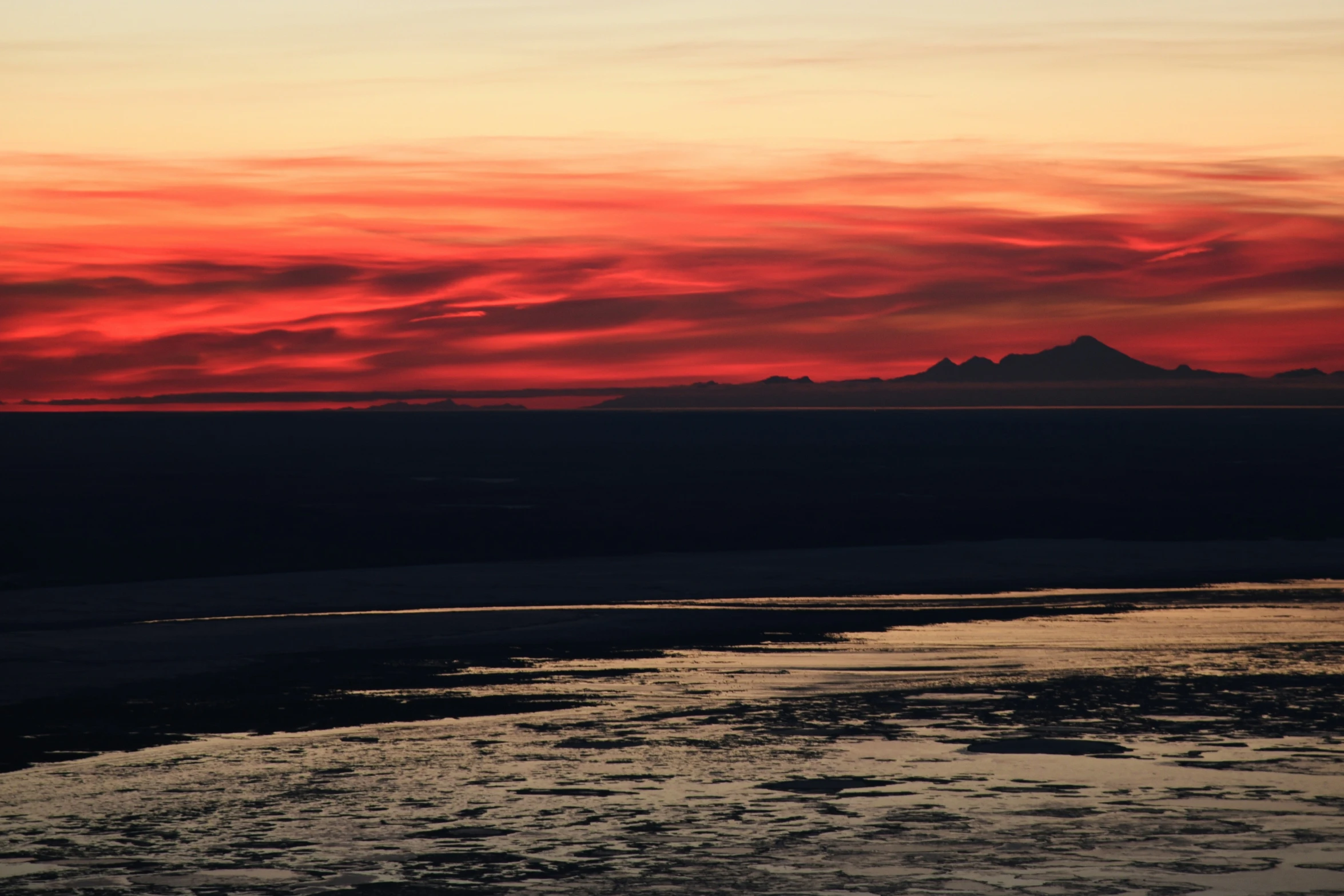 a colorful sky at sunset above the ocean