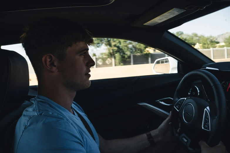 a man sitting in the drivers seat of a car