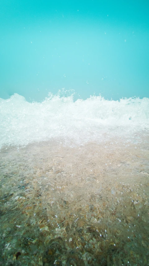 a beach with small pebbles and water in it