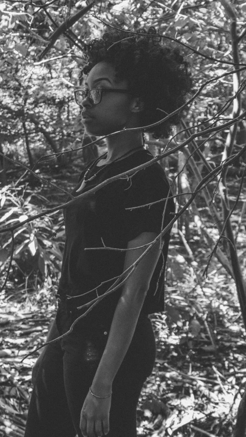 black and white po of boy in tree