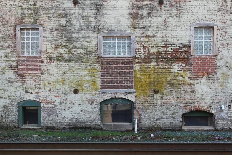 old brick buildings with windows and a bench underneath