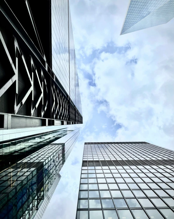 looking up at the sky from the bottom of a skyscr