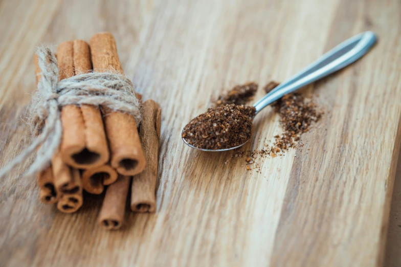 cinnamon sticks, spices and anise on a wooden surface