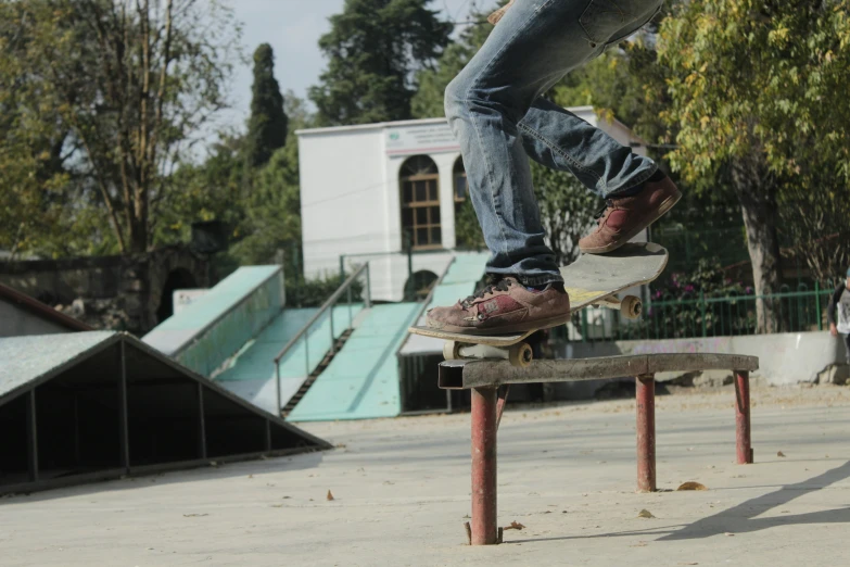 a guy riding his skateboard at a skate park