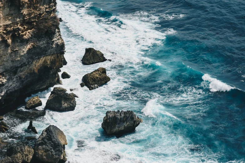 there is a rock outcropping next to the ocean