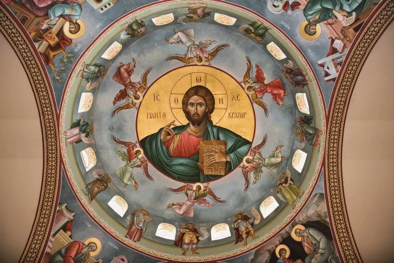 a painted icon in the ceiling of a building