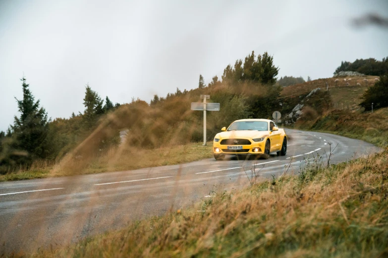 a car on the road, a sign behind it