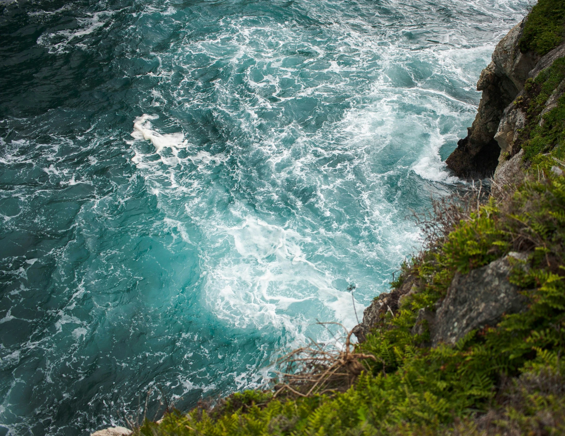 a person on surfboard looking out at the water