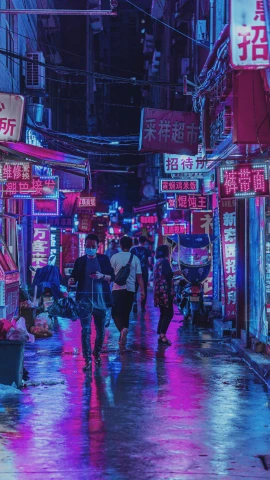 people are walking on a sidewalk through a street in the middle of an asian city