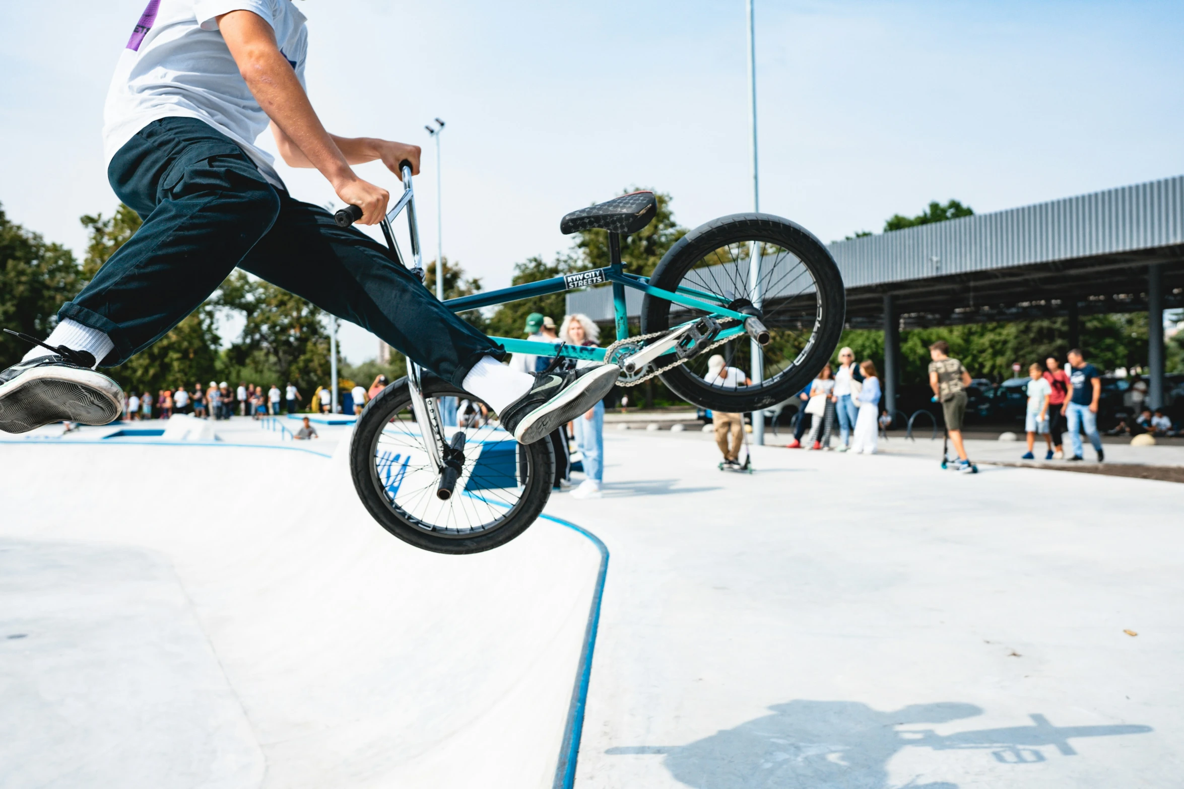 a man jumping his bike in midair over a skate park