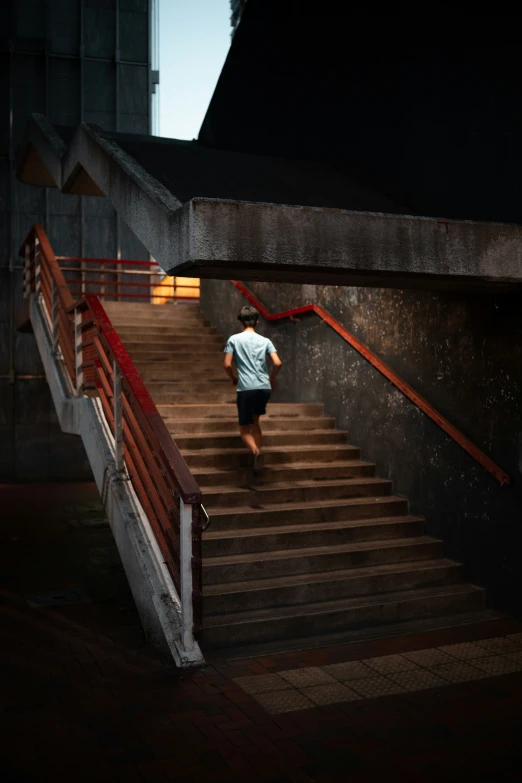 the skateboarder is coming down the stairs at night