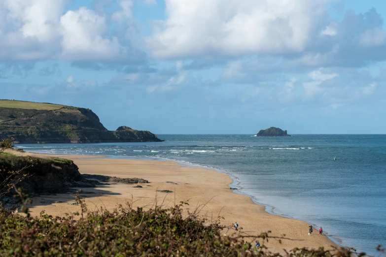 beach with two small groups of people enjoying the waves