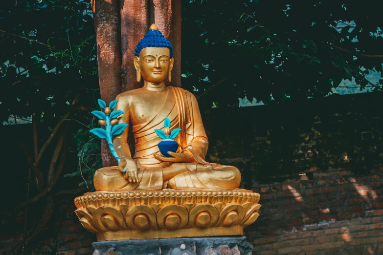 there is a statue of a buddha sitting on the side of a wall