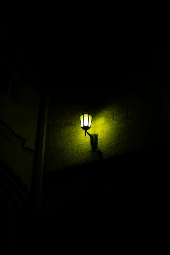 a street light lit up in the dark by the building