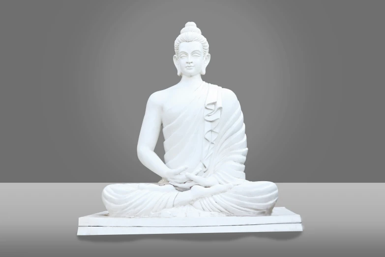 white buddha statue sitting on the ground with gray background
