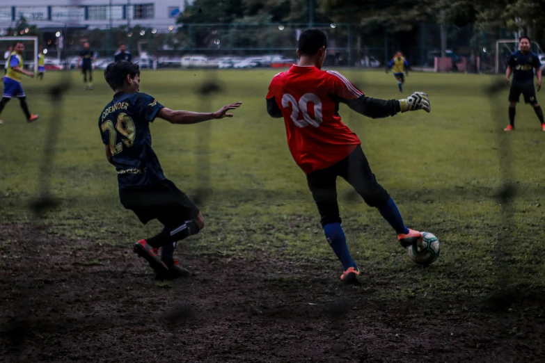 two boys play soccer with each other in a field