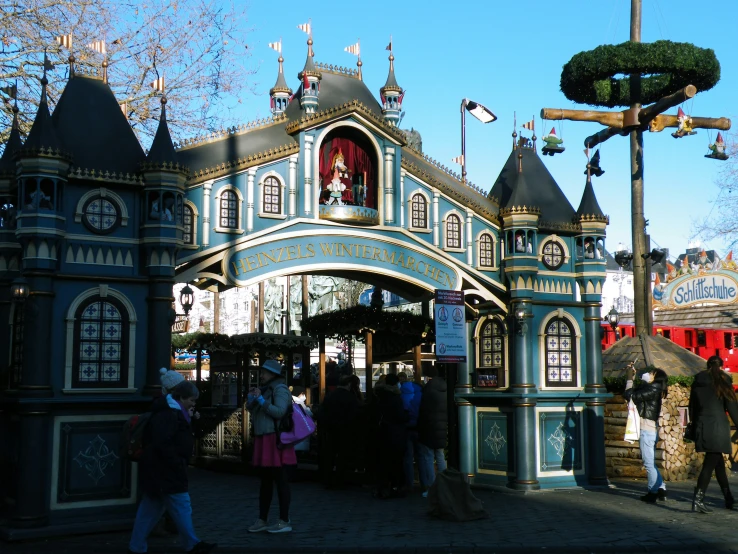 several people are standing outside a castle structure