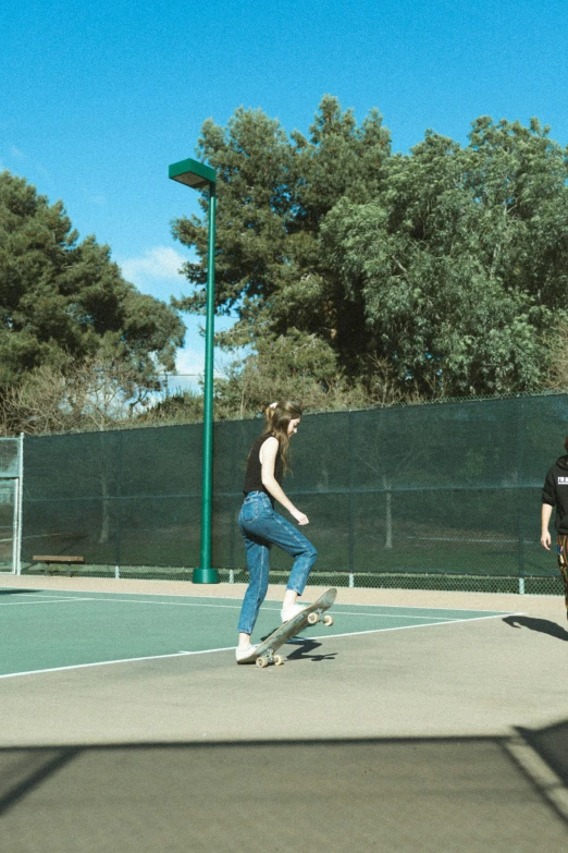 two people who are on a skateboard in the park