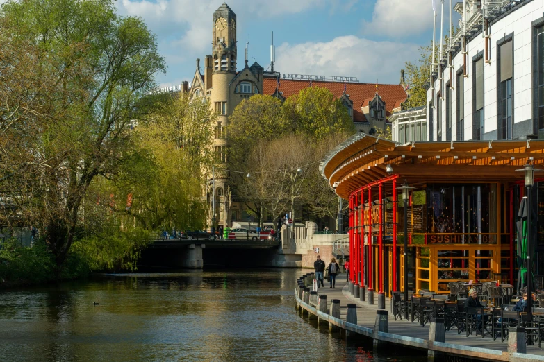 there are many colorful benches and tables by the water